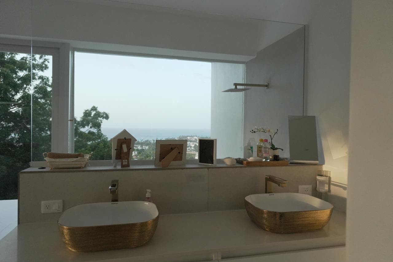Gold designer bathroom with ocean view