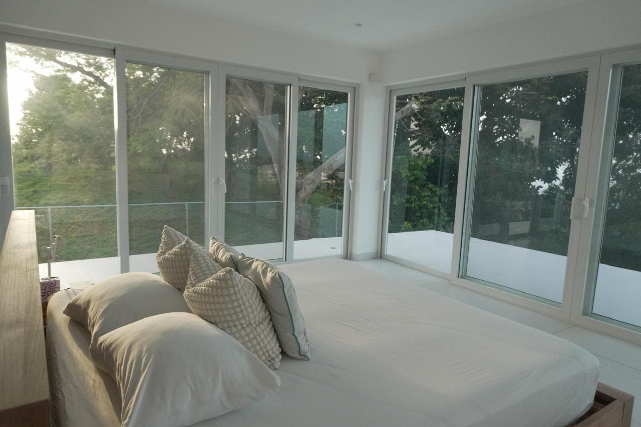 Bedroom with glass front nature view
